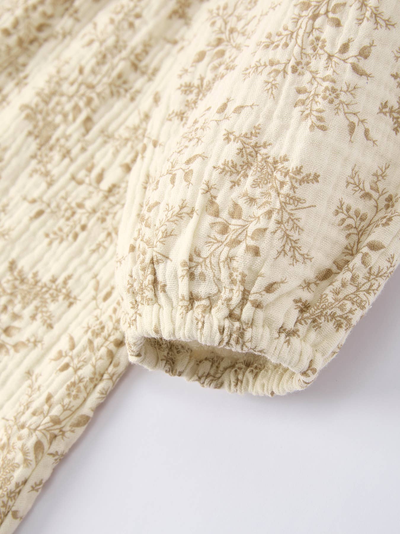 Close-up of a textured fabric with floral patterns on a white background