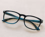 Blue eyeglasses on a light wooden surface