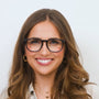 Woman wearing glasses with a plain background