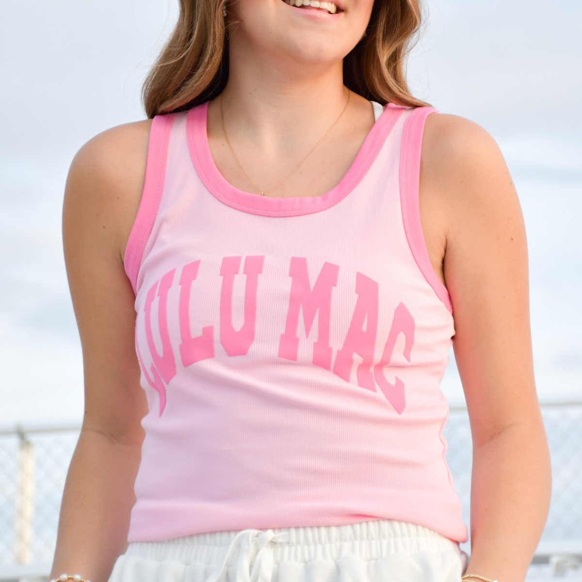 Girls' light pink sleeveless tank top with bubblegum pink trim and large front lettering