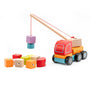 Wooden toy truck with crane lifting colorful blocks on a white background