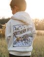 Child wearing a hoodie with 'Southern Hyde' logo in a field
