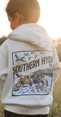 Child wearing a hoodie with 'Southern Hyde' logo in a field