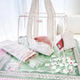 Set of white and pink bags with decorative elements on a green surface