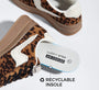 A pair of low-top sneakers with a brown and black leopard print pattern, white contrast stitching, and a gum brown sole. One shoe is shown from the side, and the other is angled from above, displaying a white 'LUCKY STEP AIR COOLED' recyclable insole.