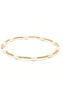Gold bracelet with pearls on a white background