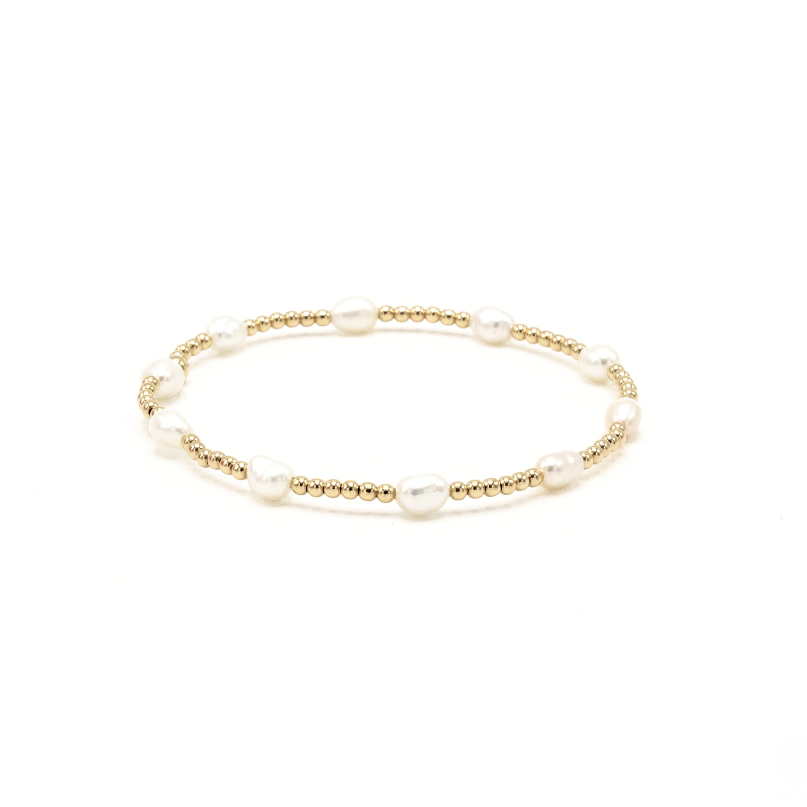 Gold bracelet with pearls on a white background