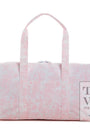 Pink and white patterned duffel bag with 'TRVL DESIGN' branding on a white background