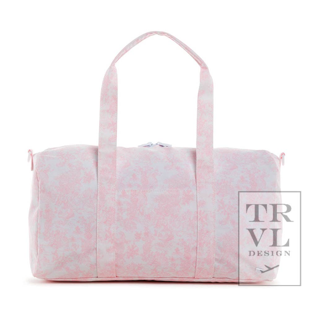 Pink and white patterned duffel bag with 'TRVL DESIGN' branding on a white background