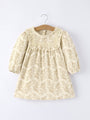 Beige lace dress on a hanger against a white background