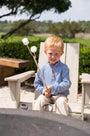 Young boy roasting marshmallows over a fire pit outdoors