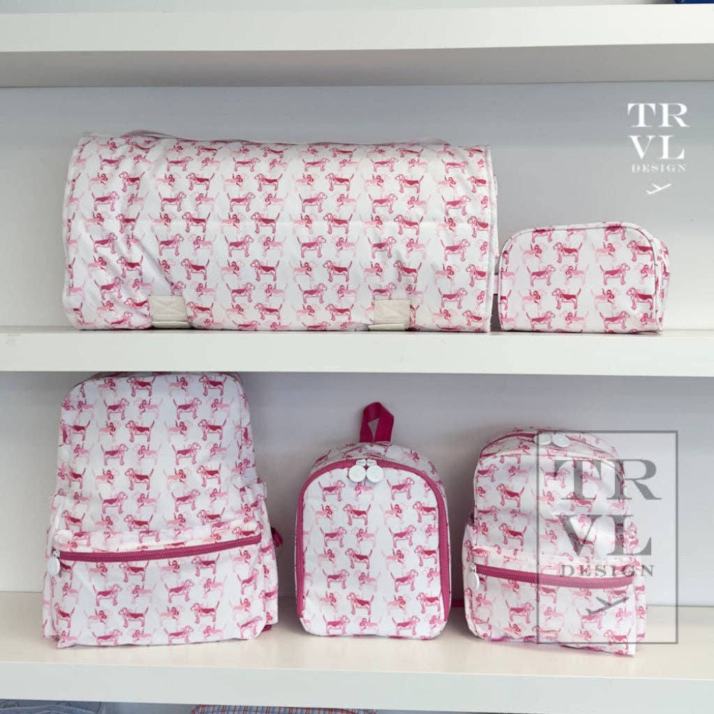 Set of pink and white patterned bags on a shelf with 'TRVLP' branding.