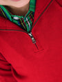 Close-up of a red sweater with a zipper and plaid collar.
