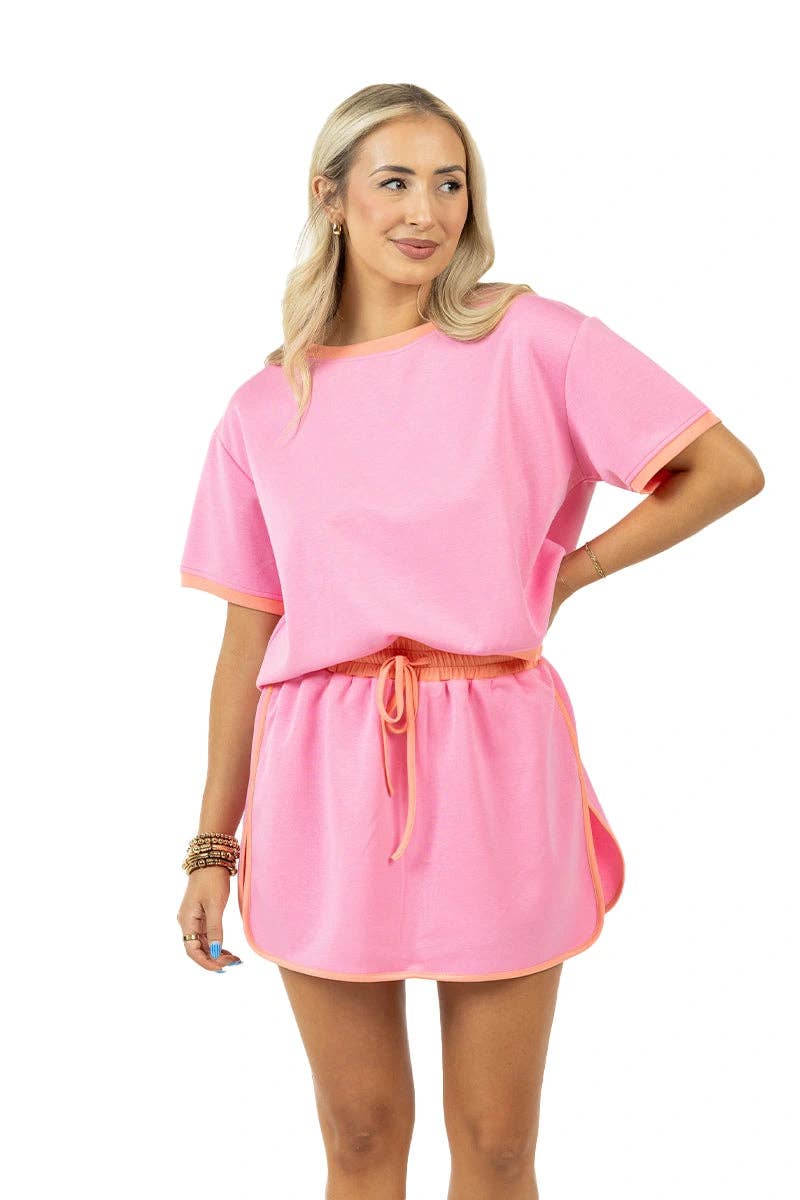 Woman wearing a pink outfit with a white background