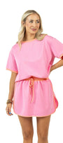 Woman wearing a pink outfit with a white background