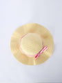 Beige straw hat with a pink band on a light gray background