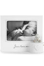 White photo frame with 'Jesus loves me' text containing a black and white photo of a baby.
