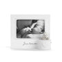 White photo frame with 'Jesus loves me' text containing a black and white photo of a baby.