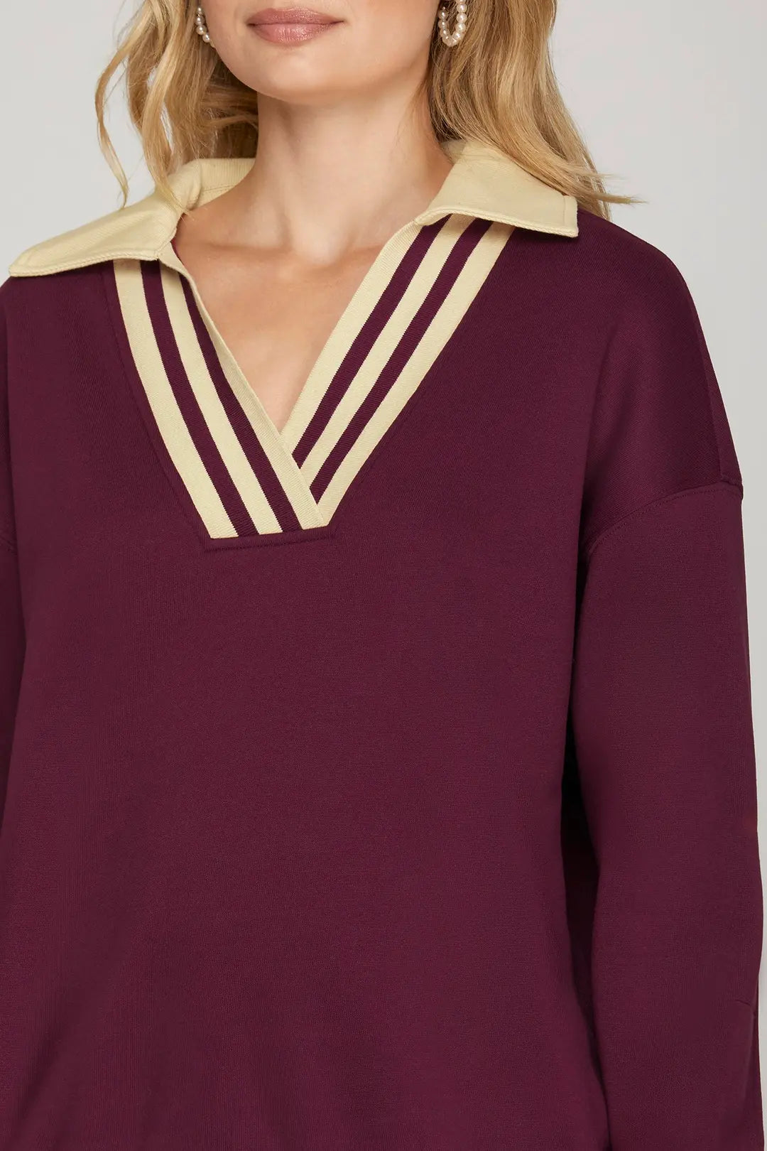 Person wearing a burgundy pullover