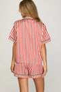 Red and white striped pajama set on a plain background