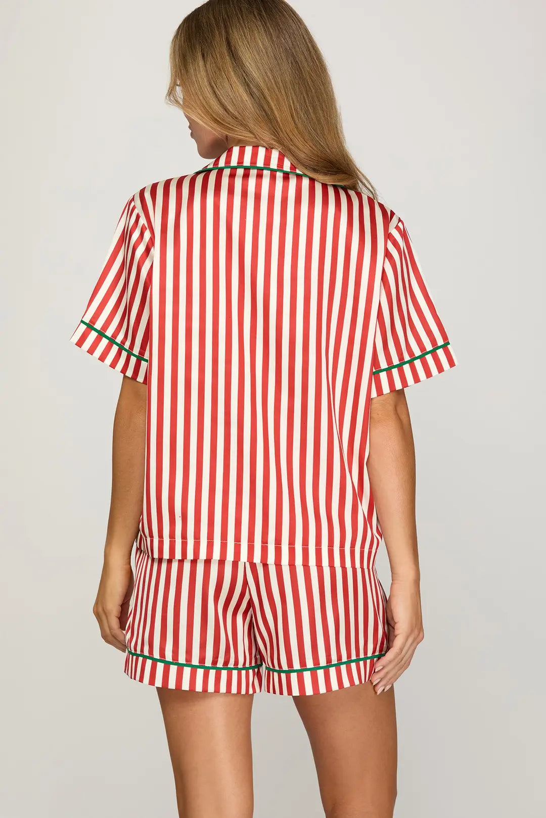 Red and white striped pajama set on a plain background