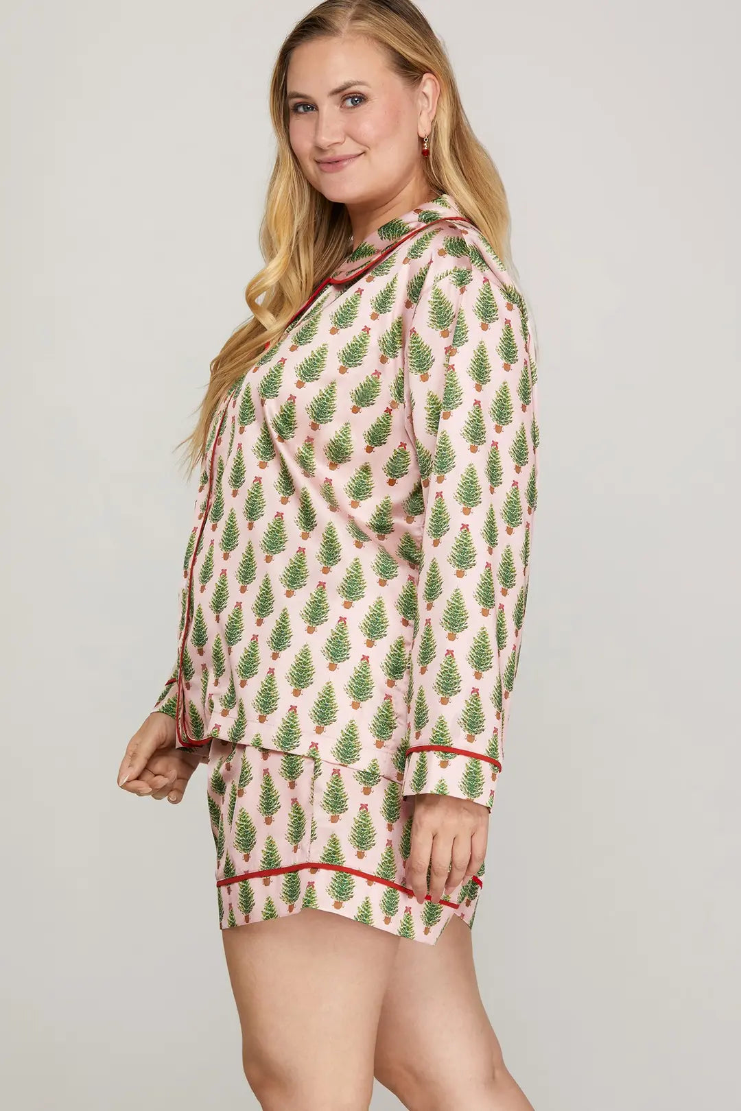 Woman wearing a patterned pajama set on a plain background