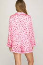 Pink pajama set with a pattern on a plain background