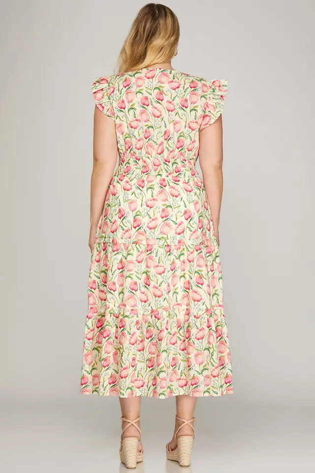 Woman wearing a floral dress on a plain background