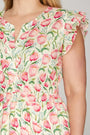 Floral dress with pink tulips and green leaves on a neutral background