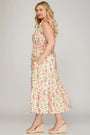 Woman wearing a floral dress on a plain background