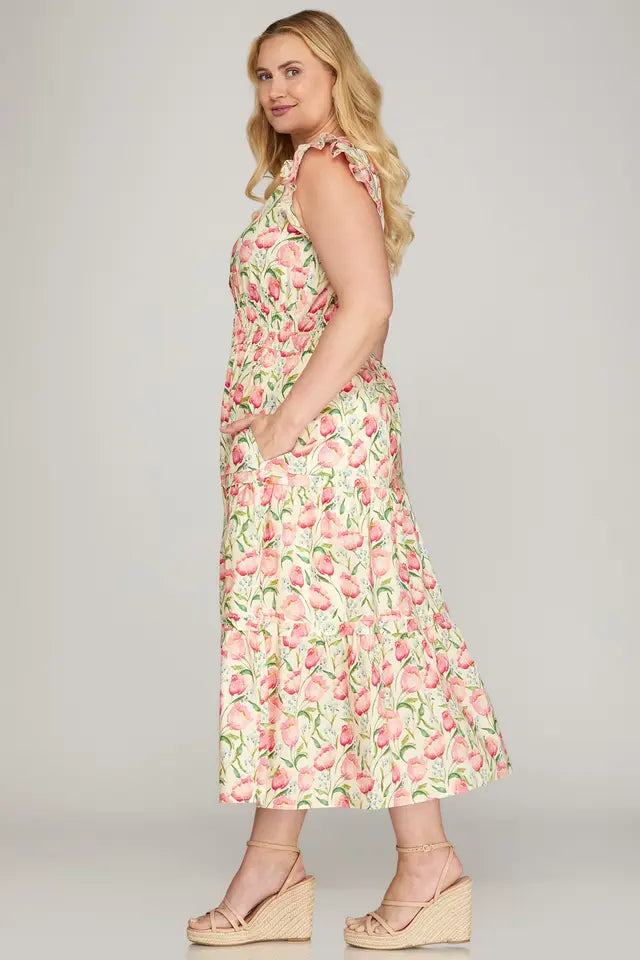 Woman wearing a floral dress on a plain background