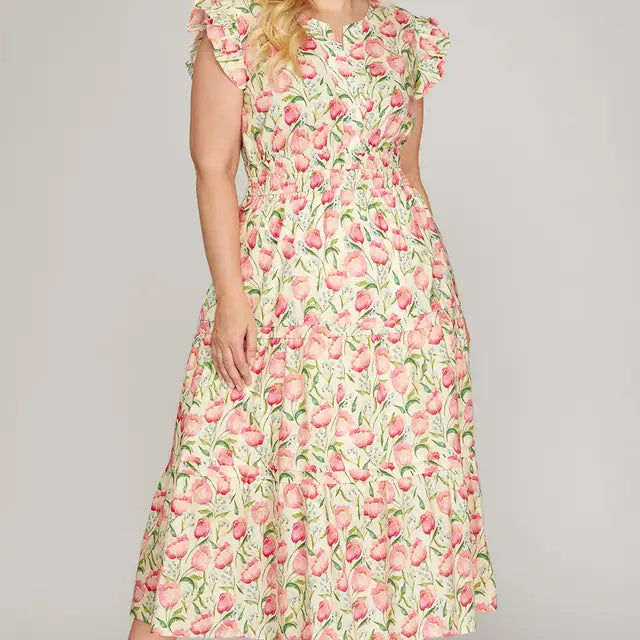 Woman wearing a floral dress on a plain background
