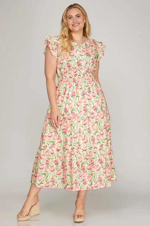Woman wearing a floral dress on a plain background