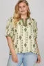 Woman wearing a patterned shirt with a blurred background