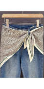 Leopard print triangle bandana with cream ends and green-trimmed borders, knot tied