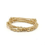 Gold beaded bracelet on a white background