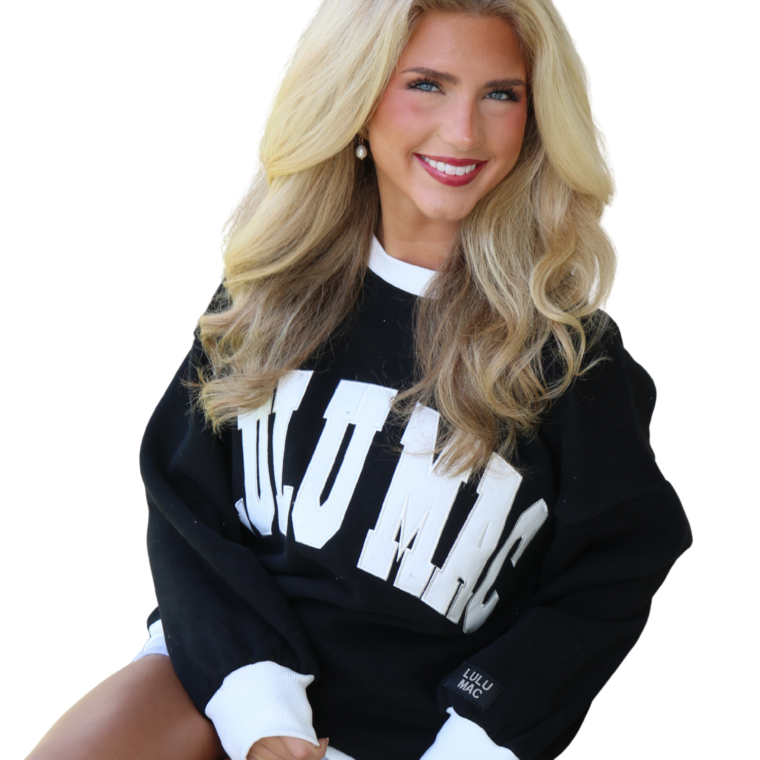 Woman wearing a black sweatshirt with white text on a white background
