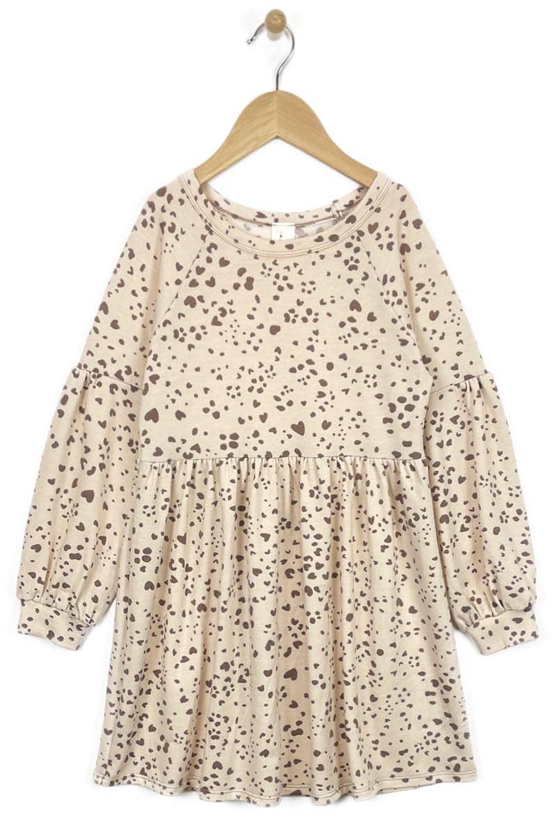 Beige dress with a subtle pattern on a hanger against a white background