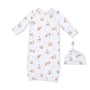 A baby sleep sack and matching knotted beanie hat set, both in white fabric with an all-over print of brown foxes and small beige leaves, displayed on a solid white background.