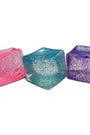 Three colorful glittery cubes on a white background