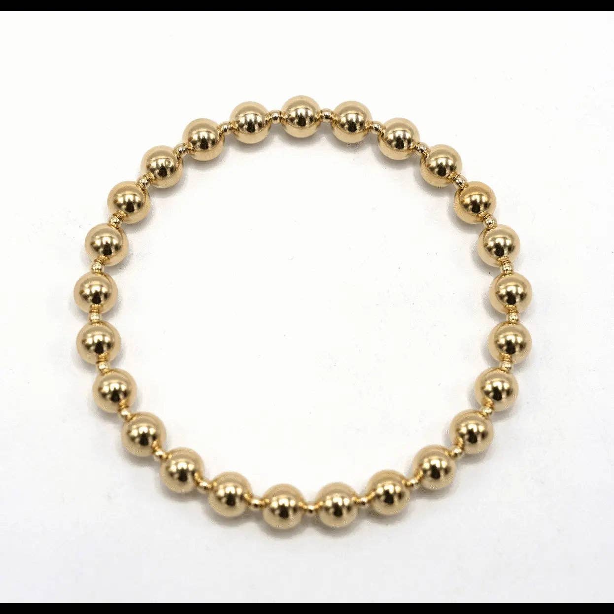 Gold beaded bracelet on a white background