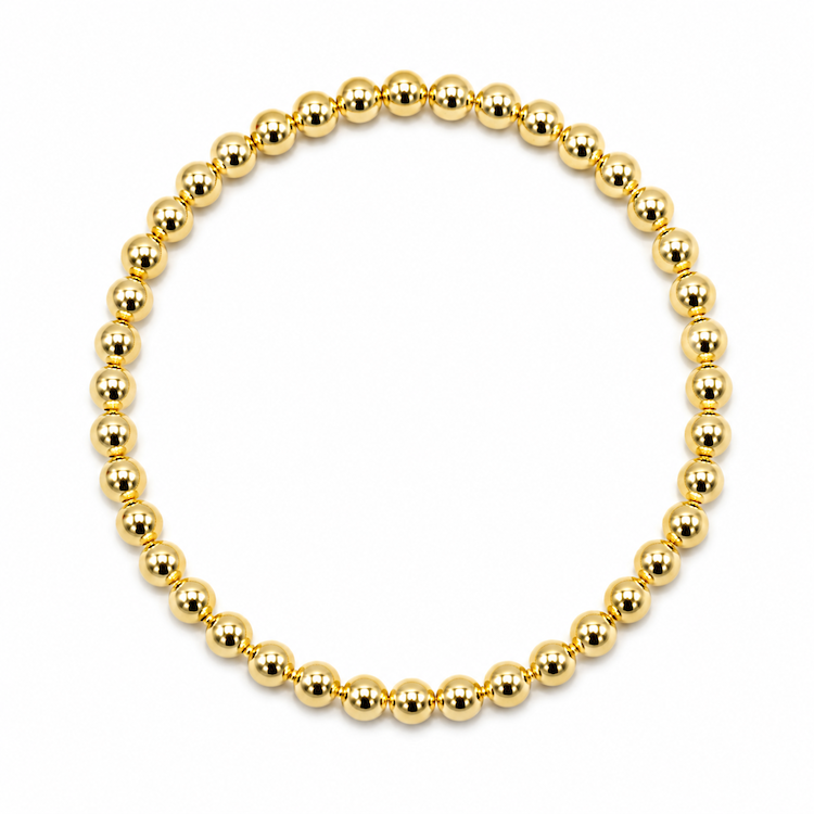 A gold beaded bracelet made of polished, reflective metallic beads arranged in a circular shape on a plain white background.