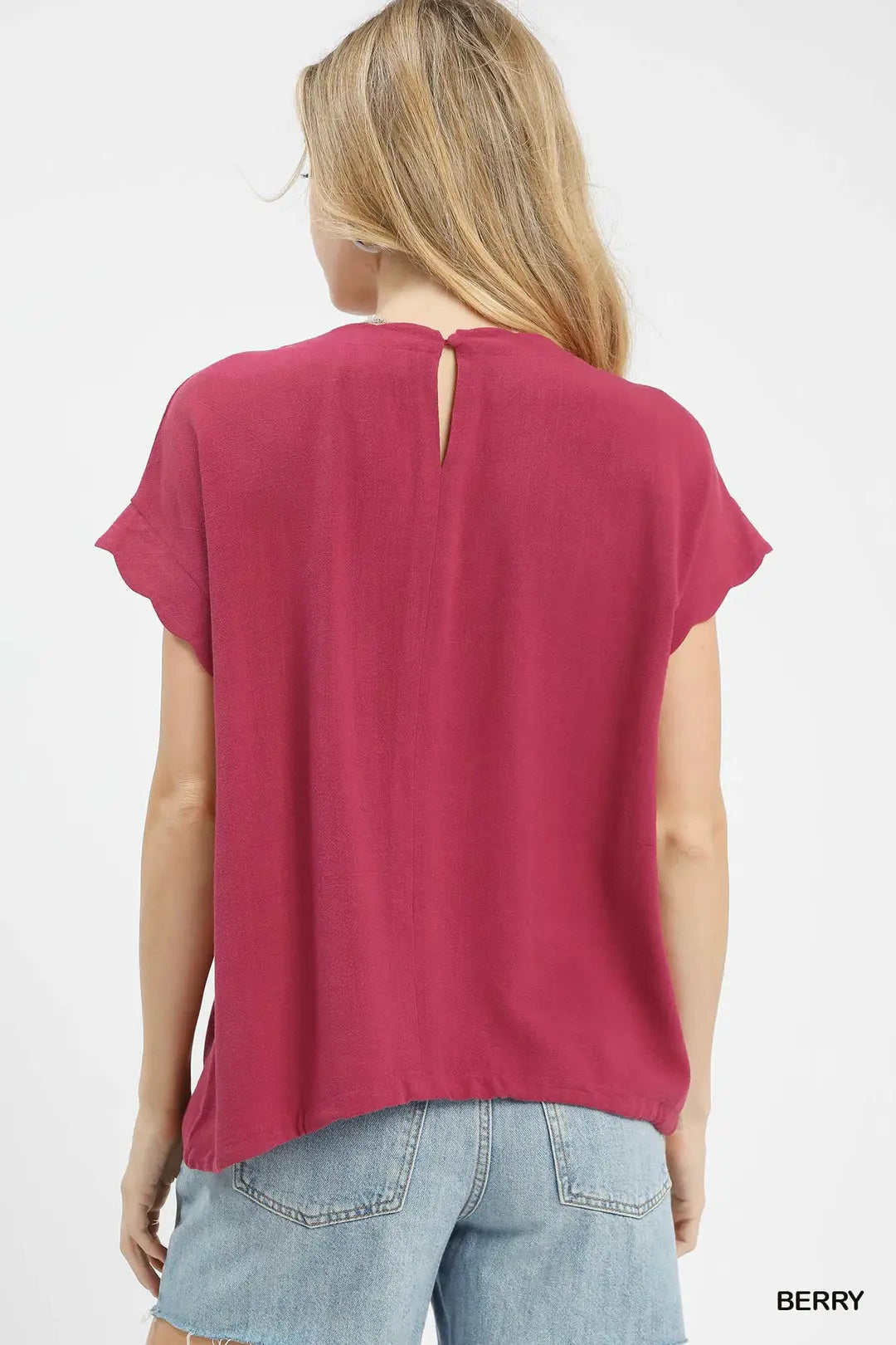 Woman wearing a berry-colored t-shirt on a white background