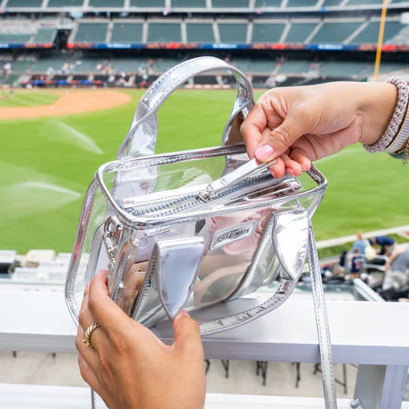 Clear handbag with a baseball field in the background