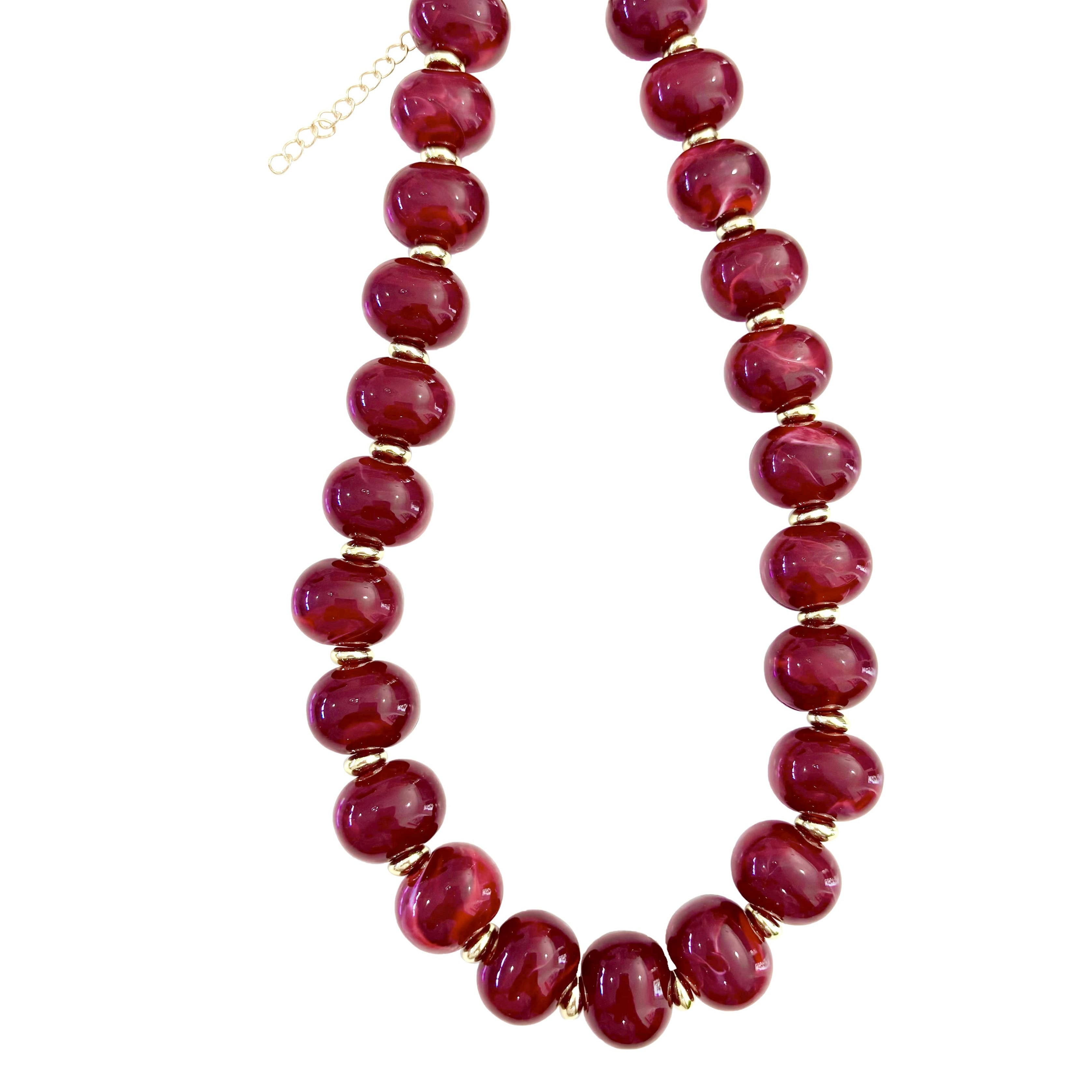 Chunky beaded necklace with marbled red oval beads and gold-tone chain