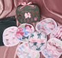 7-day makeup eraser set with six pastel round cloth erasers and a green pouch