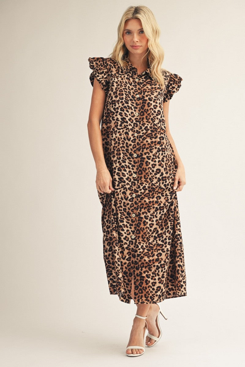 Woman wearing a leopard print dress on a plain background