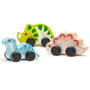 Set of three wooden dinosaur toys on a white background