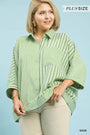 Woman wearing a green striped shirt with text 'Plus Size' and 'Sage' on a light blue background