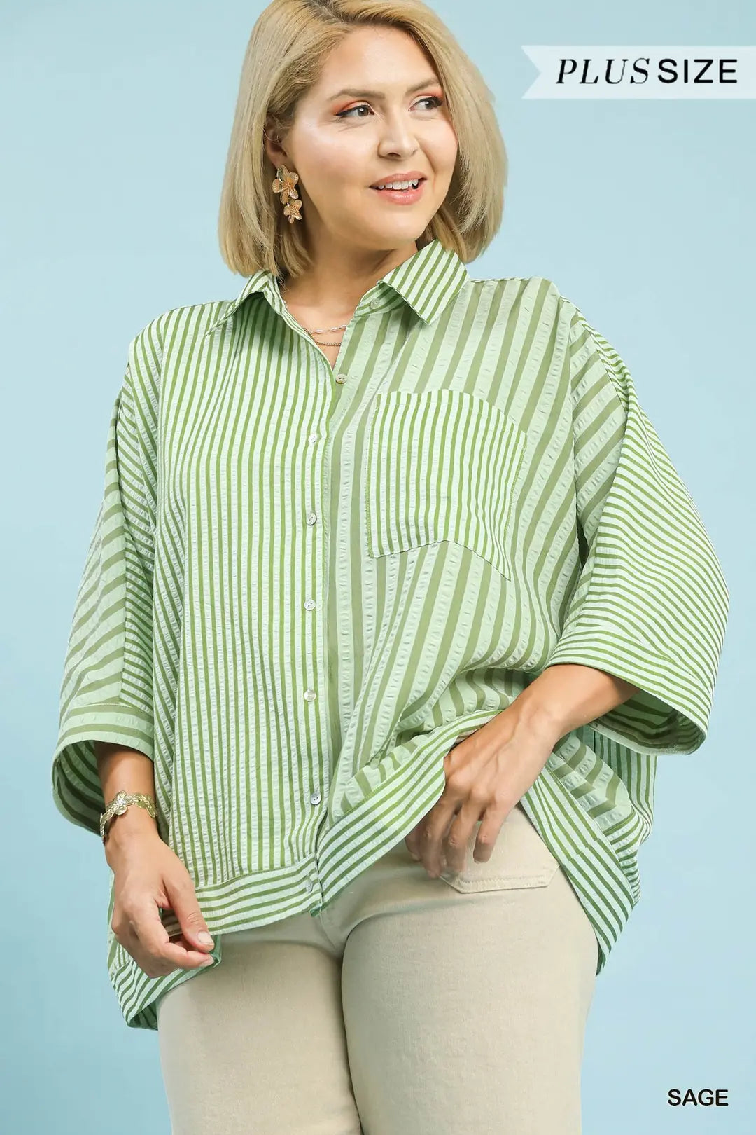 Woman wearing a green striped shirt with text 'Plus Size' and 'Sage' on a light blue background
